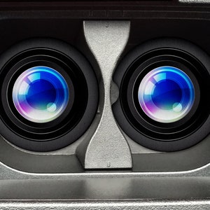 May include: Close-up of a VR headset interior. The image shows two large, circular lenses with concentric black rings. The lenses reflect a colorful, bright light. The headset's frame is a light gray color.