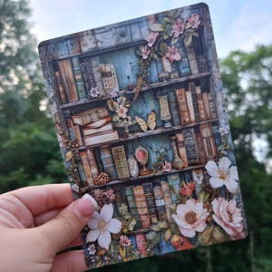 May include: A vintage-style bookshelf with a blue background, filled with books and decorated with flowers, butterflies, and other decorative elements.