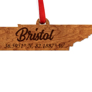 May include: Wooden ornament shaped like the state of Tennessee with the word "Bristol" and the coordinates "36.5951° N, 82.1887° W" engraved on it.