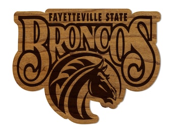 May include: A wooden sign with the words "Fayetteville State Broncos" in brown lettering. A brown horse head is in the center of the sign.