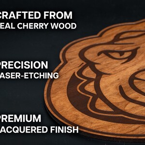 a wooden object with a carved design, including a face and a mouth, and it is described as a "crafted from real cherry wood" and "precision laser-etching".