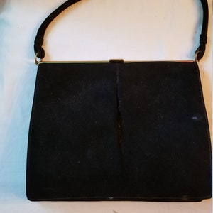 Black purse with gold clasp
