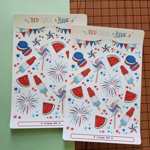 May include: Two sheets of stickers with a red, white and blue patriotic theme. The stickers feature fireworks, stars, watermelon slices, popsicles and pinwheels. The text on the sheets reads "RED. WHITE & BLUE" and "STICKER BUN".