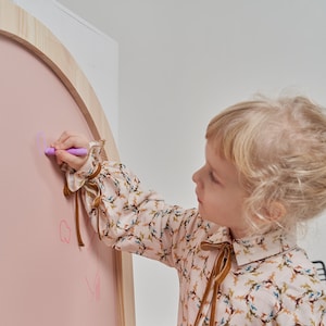 Close up of chalk drawing on a pink magnetic chalkboard for kids