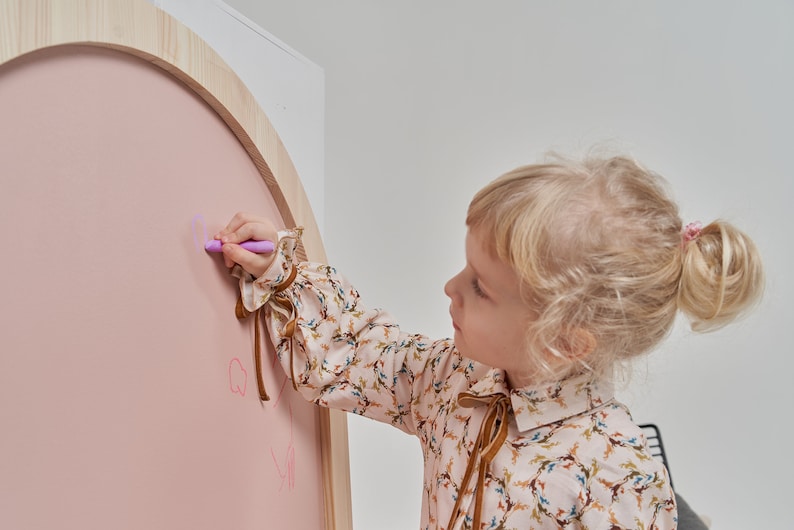 Close up of chalk drawing on a pink magnetic chalkboard for kids
