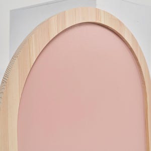Close up of pink arch magnetic chalkboard with natural pine wood frame