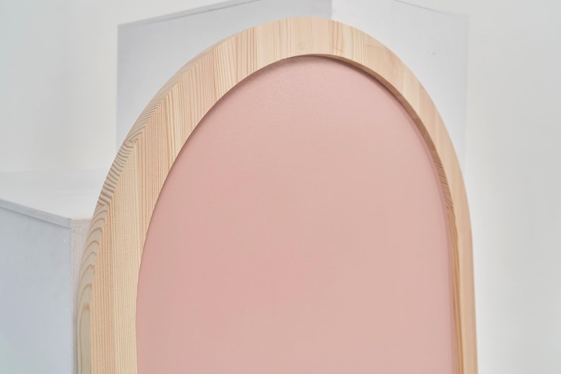 Close up of pink arch magnetic chalkboard with natural pine wood frame