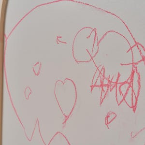 Magnets attached to a magnetic chalkboard surface for creative learning and play