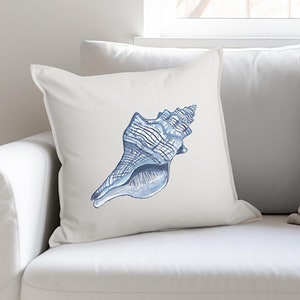 May include: A white throw pillow with a blue seashell illustration. The seashell is detailed with white lines and has a spiral shape.
