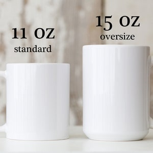 May include: Two white ceramic mugs, one labeled "11 oz standard" and the other "15 oz oversize".
