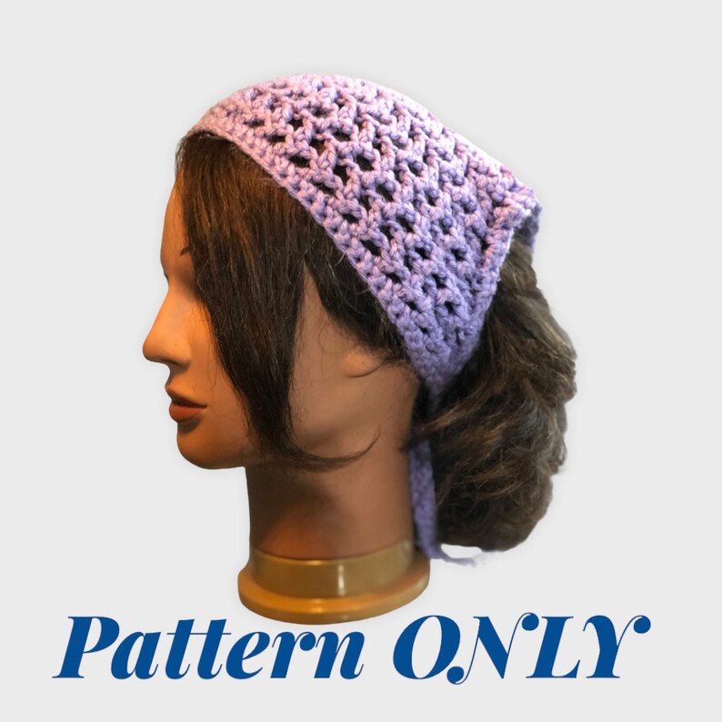 Op de afbeelding: Een lavendelkleurig gehaakt hoofdband met een kantpatroon. Het hoofdband is vastgebonden aan de achterkant van het hoofd.