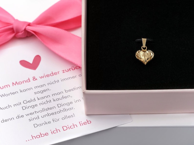 May include: A small gold heart pendant charm in a pink gift box with a message that reads "...habe ich Dich lieb" which translates to "...I love you".