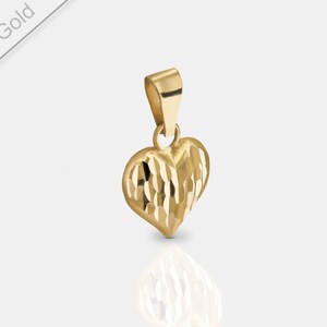May include: A gold heart-shaped pendant with a textured surface. The pendant is made of 585er gold.