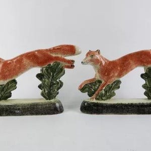 A rare pair of handpainted Rye Pottery, England figures in the form of foxes. Of foxhunting interest and perfect for ornamental bookends.