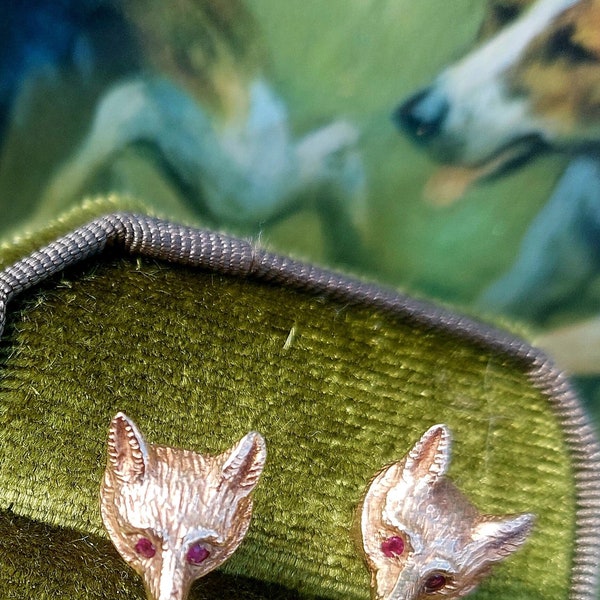 A vintage pair of fox mask earrings. 9ct gold fox head studs. Fully hallmarked with ruby faceted eyes. English foxhunting attire. Gold fox.