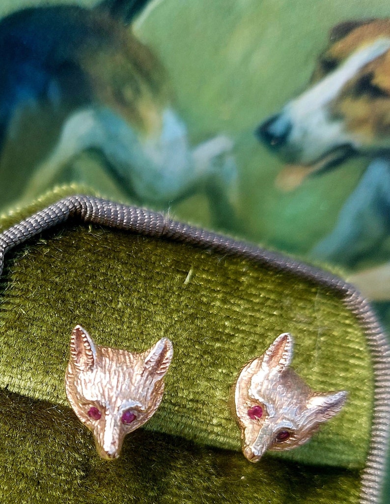 A vintage pair of fox mask earrings. 9ct gold fox head studs. Fully hallmarked with ruby faceted eyes. English foxhunting attire. Gold fox. image 1