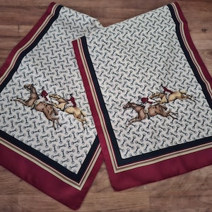A ladies long line scarf of English fox hunting interest. Featuring snaffles throughout and victorian style galloping huntsmen. Tally - ho !