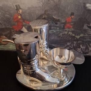 A mid century silver plated cruet set of equestrian or fox hunting interest. Carefully crafted with salt and pepper cellar and mustard pot.