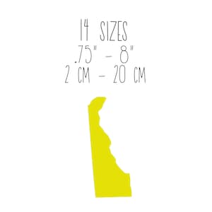 May include: A yellow outline of the state of Delaware on a white background. Text above the state reads "14 SIZES .75" - 8" 2 CM - 20 CM". The image is a simple, minimalist design.