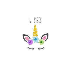 May include: A white unicorn face with closed eyes, a gold horn, and a flower crown with pink, purple, blue, and green flowers. The text "6 SIZES" is above the unicorn.