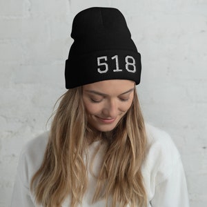 May include: Black beanie with white embroidered text "518" on the front.