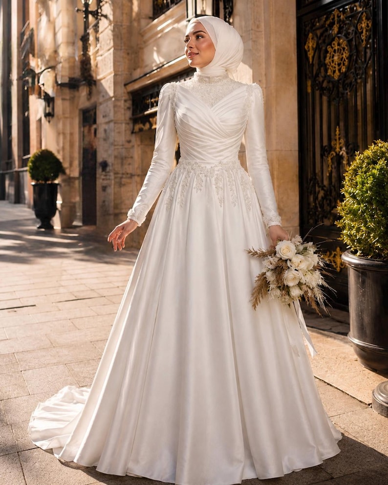 Hijab friendly modest bridal gown with high neck satin styling and graceful coverage for a Muslim wedding look