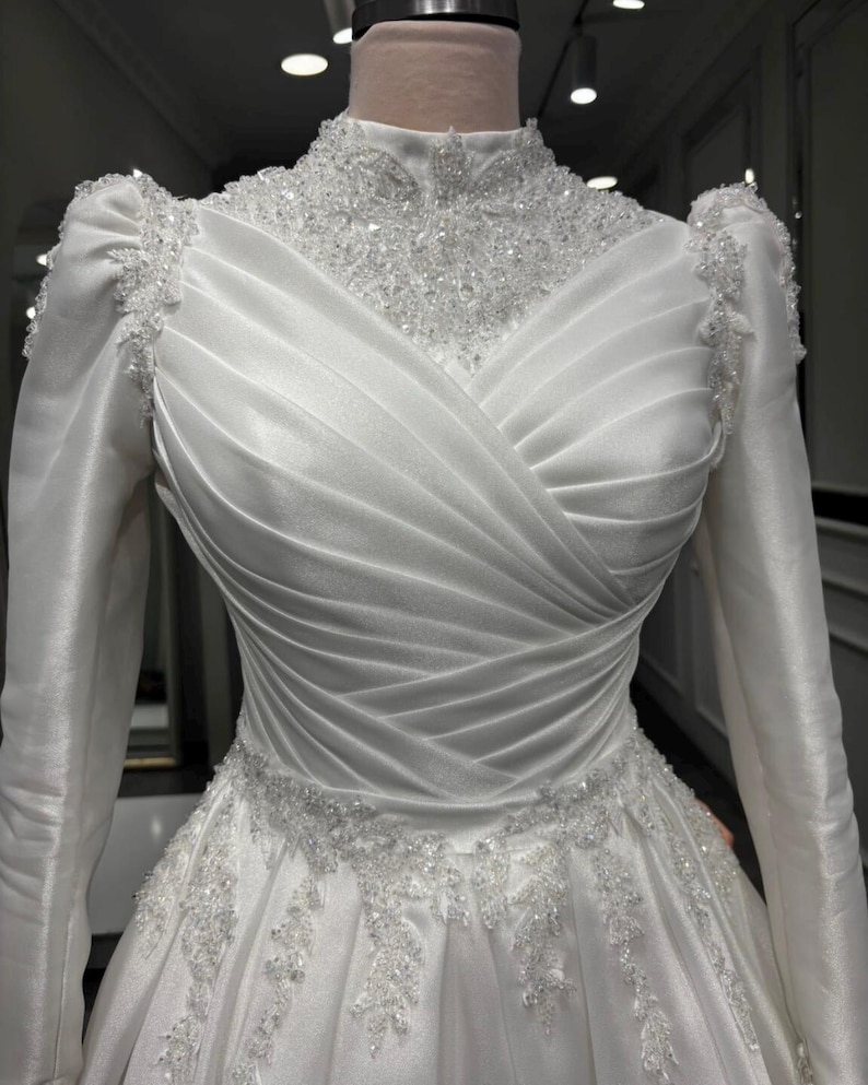 Draped bodice satin bridal gown with romantic detailing and sophisticated bridal style