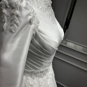 Simple wedding dress for an elegant bride with timeless satin styling and graceful bridal sophistication