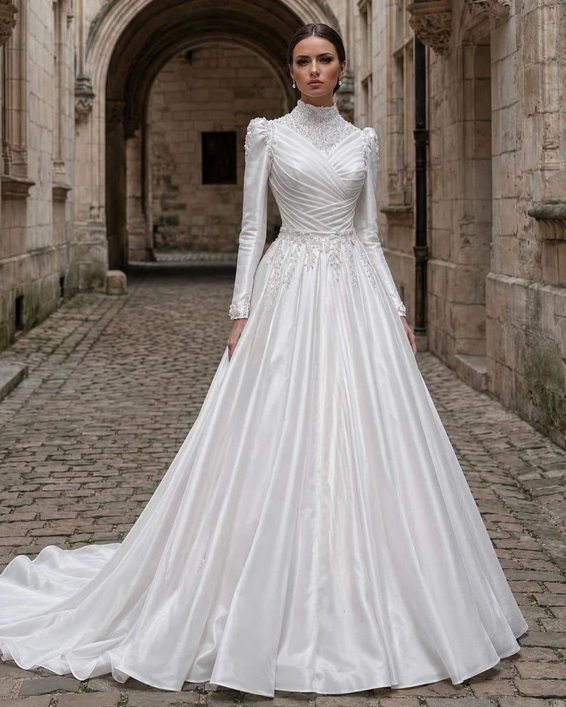 Satin ball gown with pearl beaded details, graceful volume and classic bridal elegance