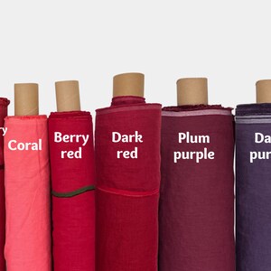 May include: Six rolls of fabric in various shades of red and purple. The fabric rolls are labeled "Raspberry pink", "Coral", "Berry red", "Dark red", "Plum purple", and "Dark purple".