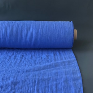 Cornflower blue linen fabric by the metre. Softened linen fabric by the yard. Medium weight linen for sewing clothing or home textile.