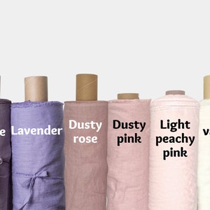 May include: Six rolls of fabric in various shades of pink, lavender, and white. The fabric rolls are labeled "Mauve", "Lavender", "Dusty rose", "Dusty pink", "Light peachy pink", and "vanilla".
