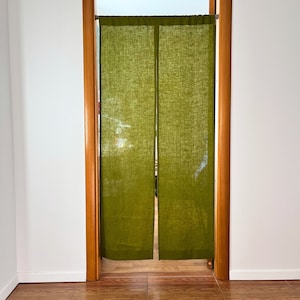 May include: A pair of green linen curtains hanging in a doorway. The curtains are made of a lightweight fabric and have a natural, rustic look.