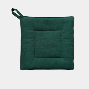 May include: A dark green quilted pot holder with a loop handle.