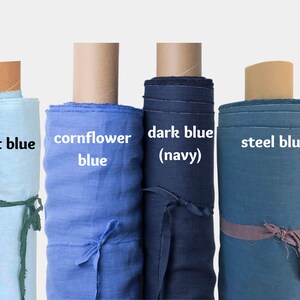 May include: Four rolls of fabric in different shades of blue. From left to right: light blue, cornflower blue, dark blue (navy), and steel blue.