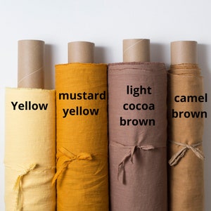 May include: Four rolls of fabric in different shades of yellow and brown. The fabric rolls are labeled "Yellow", "Mustard Yellow", "Light Cocoa Brown", and "Camel Brown".