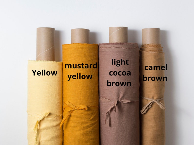 May include: Four rolls of fabric in different shades of yellow and brown. The fabric rolls are labeled "Yellow", "Mustard Yellow", "Light Cocoa Brown", and "Camel Brown".