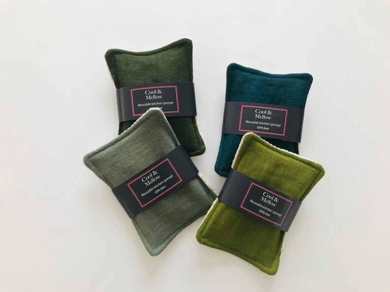 May include: Four reusable kitchen sponges in various shades of green. Each sponge has a black label with the text "Cool & Mellow Reusable Kitchen Sponge 100% linen" printed on it.