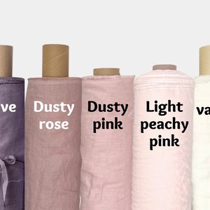 May include: Five rolls of fabric in different shades of pink and purple. The fabric rolls are labeled "mauve", "dusty rose", "dusty pink", "light peachy pink", and "vanilla".