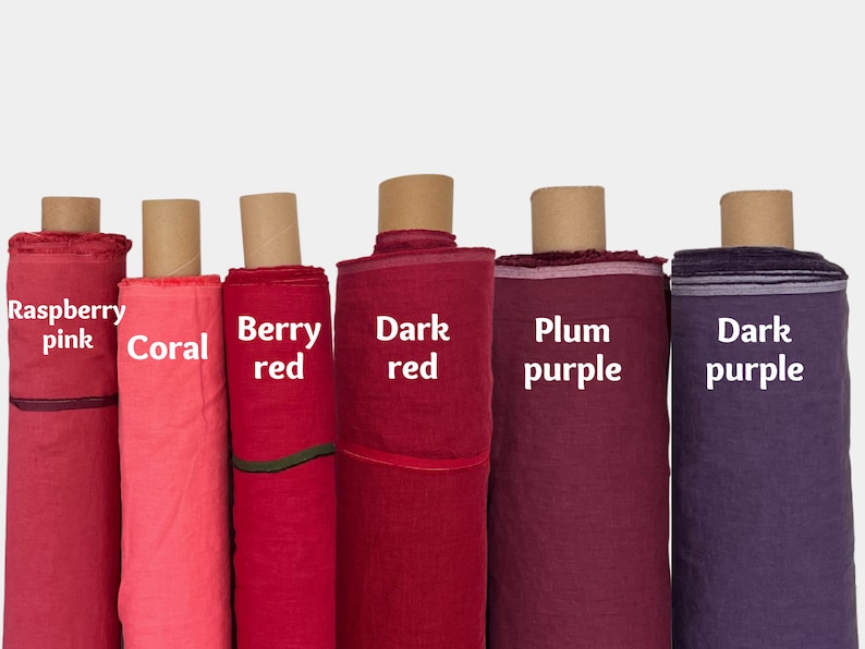 May include: Six rolls of fabric in various shades of red and purple. The fabric rolls are labeled "Raspberry pink", "Coral", "Berry red", "Dark red", "Plum purple", and "Dark purple".