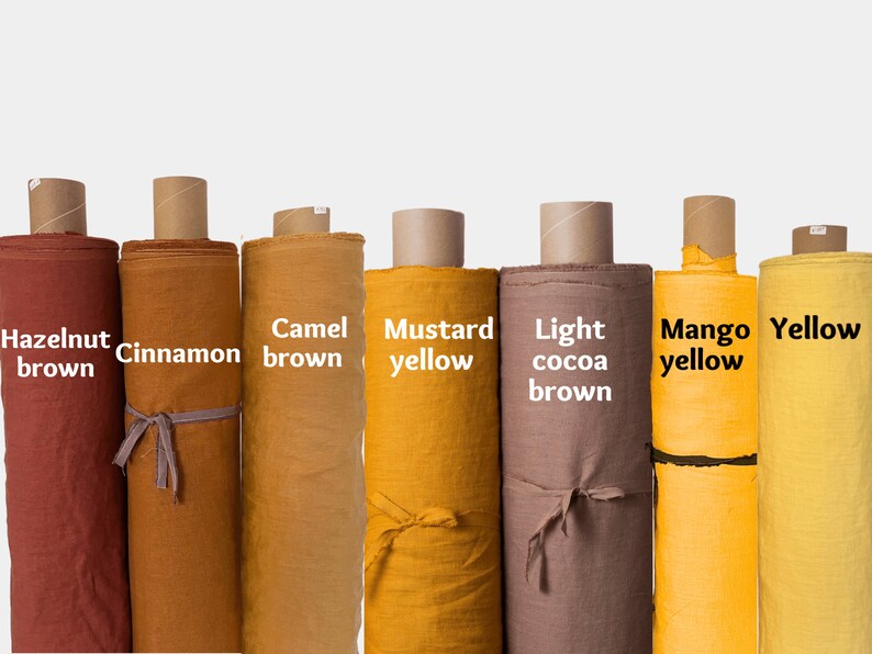 May include: Eight rolls of fabric in various shades of brown and yellow. The fabric rolls are labeled with the following colors: Hazelnut brown, Cinnamon, Camel brown, Mustard yellow, Light cocoa brown, Mango yellow, and Yellow.