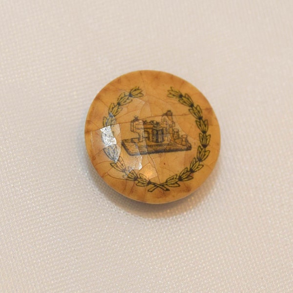 Antique celluloid button with rivet back, Vesta temple ruins with laurel border (#165)