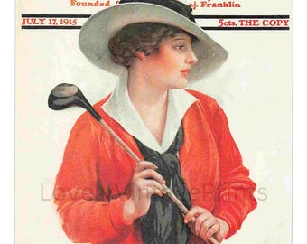 May include: The cover of The Saturday Evening Post magazine from July 17, 1915, features a woman wearing a white hat and a red jacket, holding a golf club. The text "The Saturday Evening Post" is printed in black at the top of the cover.