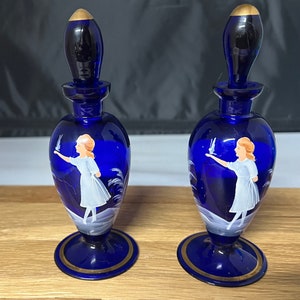 Two Mary Gregory cobalt blue perfume bottles