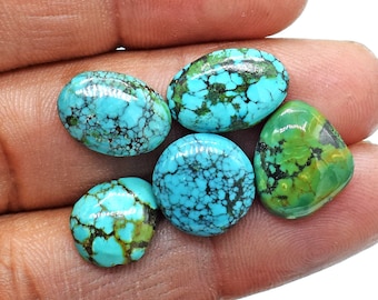 May include: Five oval-shaped turquoise cabochons with a blue-green color and brown matrix. The stones have a smooth, polished surface.