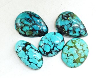 May include: Five turquoise cabochons, each with a unique pattern of black and green veins. The stones are smooth and polished, with a pear-shaped and oval shape.