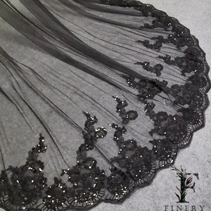 May include: Black tulle fabric with a scalloped edge and black sequin embroidery.