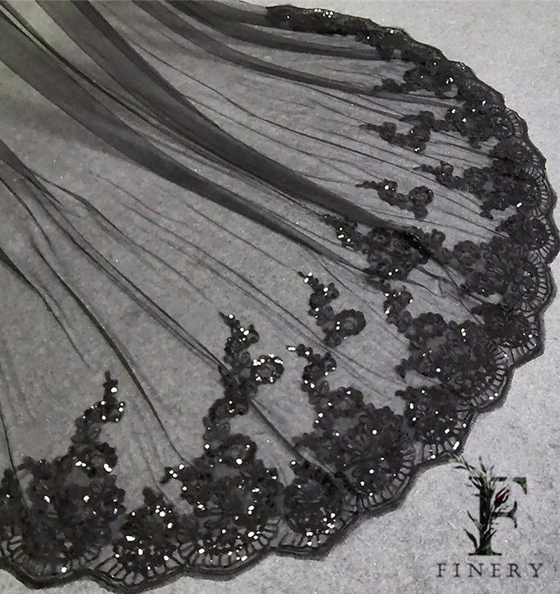 May include: Black tulle fabric with a scalloped edge and black sequin embroidery.