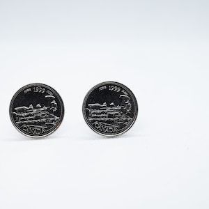 Peut inclure: Deux pièces de monnaie canadiennes en argent avec l'année 1999 et le mot "CANADA" dessus. Les pièces présentent un motif d'un bâtiment avec un train devant.