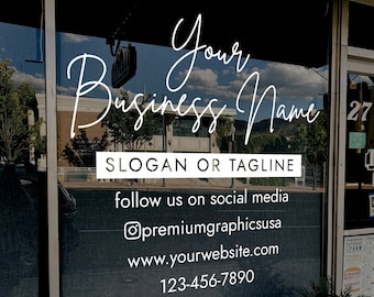 Op de afbeelding: Een winkelruit met een wit bord waarop staat "Your Business Name", "Slogan or Tagline", "follow us on social media", "@premiumgraphicsusa", "www.yourwebsite.com" en "123-456-7890".